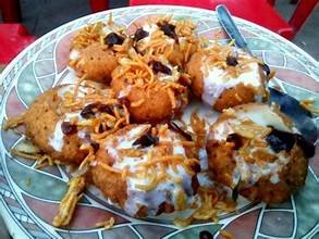 Doi fuchka topped with yogurt and tamarind chutney