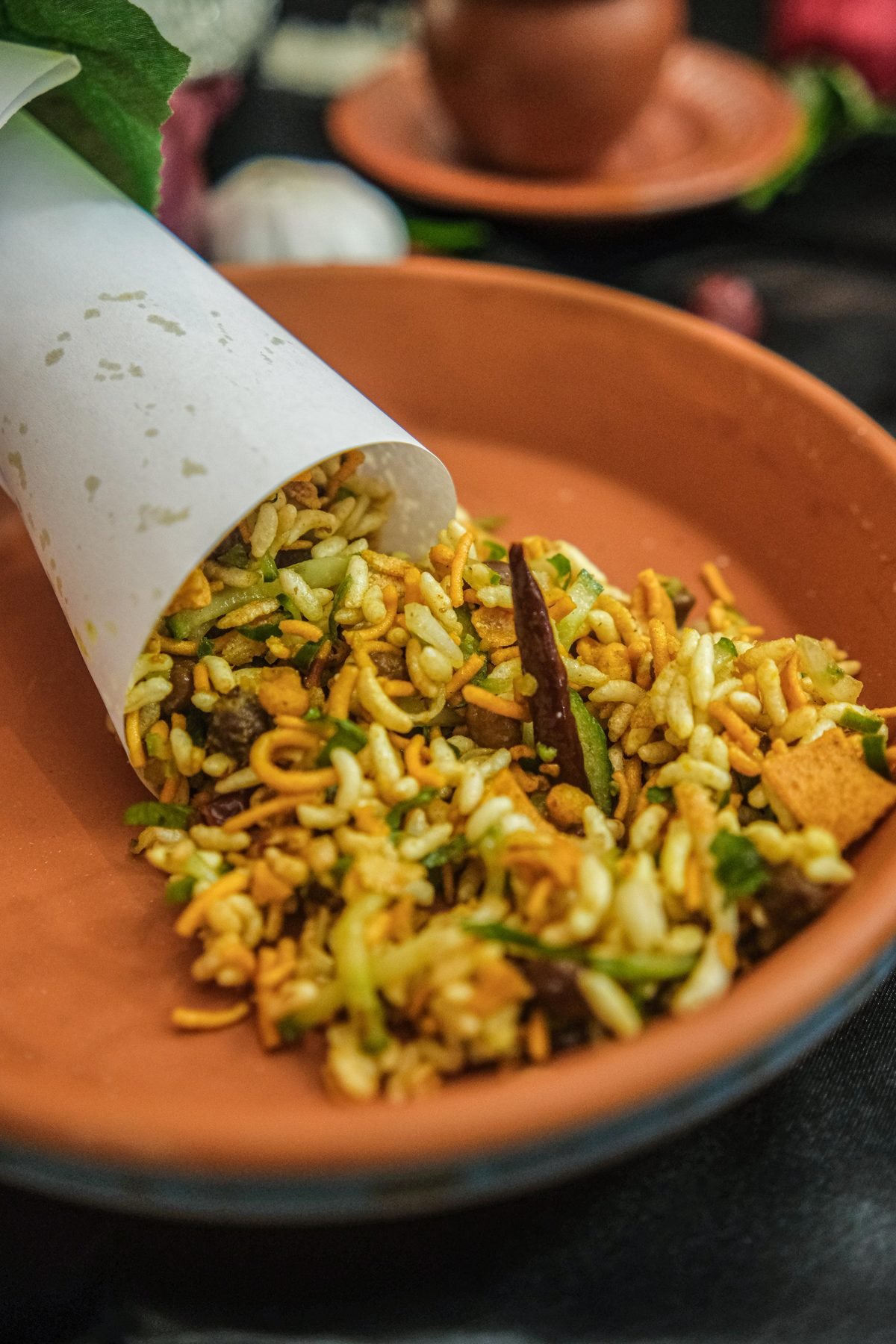 Spicy jhal muri street snack in a paper cone