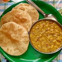 Luchi with daal — fried bread served with lentil curry