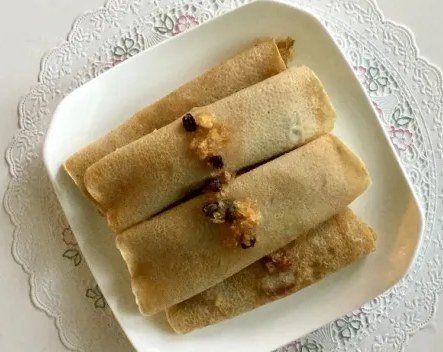 Patishapta, rolled rice crepes with sweet filling