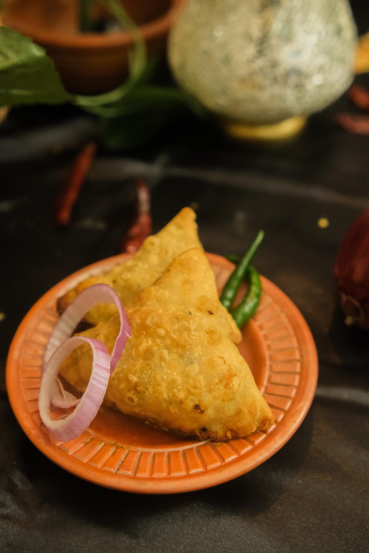 Golden fried singara served with onion and green chili